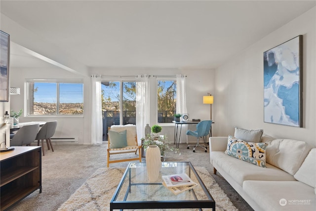 living room featuring baseboard heating, plenty of natural light, and carpet floors