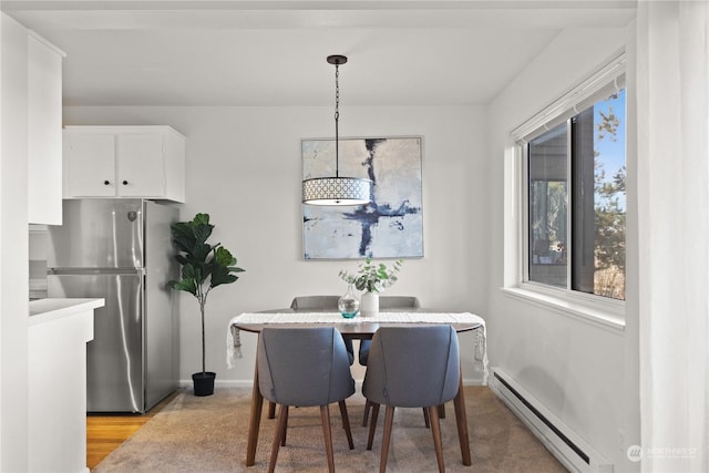 dining room featuring light wood-type flooring and baseboard heating