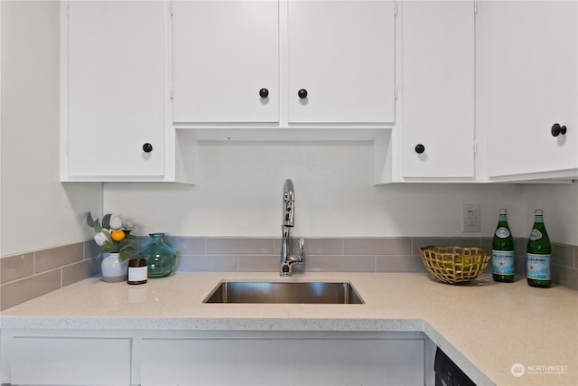 kitchen featuring white cabinetry and sink