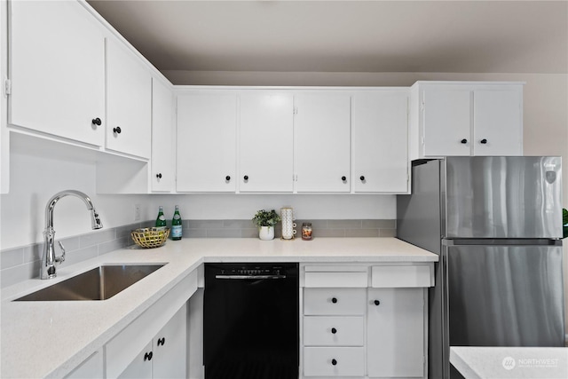 kitchen featuring white cabinets, sink, stainless steel refrigerator, and dishwasher