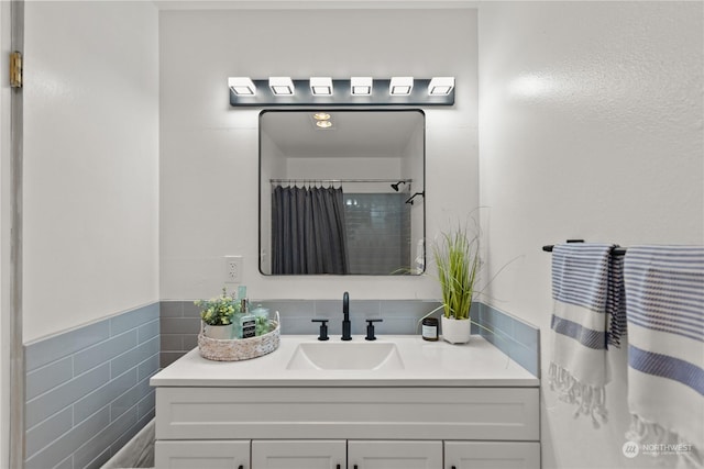 bathroom with vanity, tile walls, and curtained shower