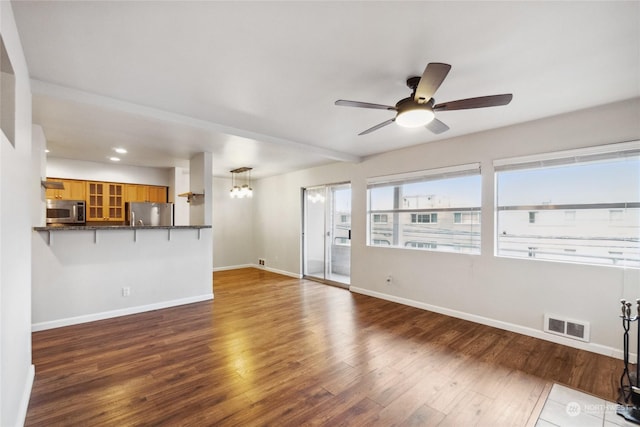 unfurnished living room with hardwood / wood-style flooring and ceiling fan