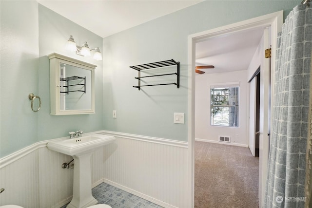 bathroom featuring ceiling fan and toilet