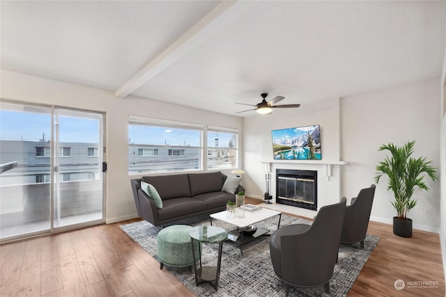 living room featuring hardwood / wood-style floors, beam ceiling, and ceiling fan