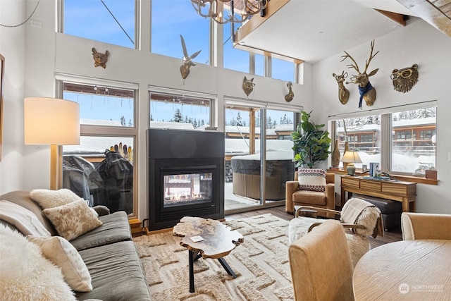 sunroom / solarium featuring a notable chandelier and a multi sided fireplace