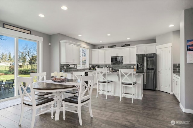 dining area featuring dark hardwood / wood-style flooring