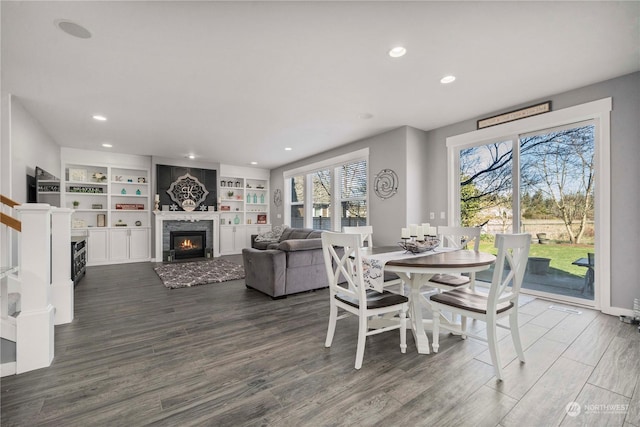 dining area featuring dark wood-type flooring and built in shelves