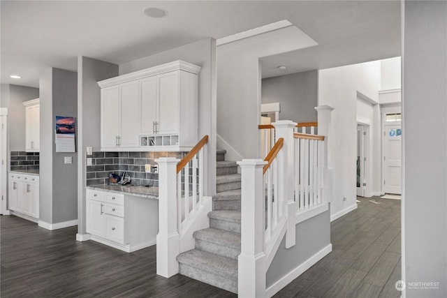 stairway with hardwood / wood-style floors