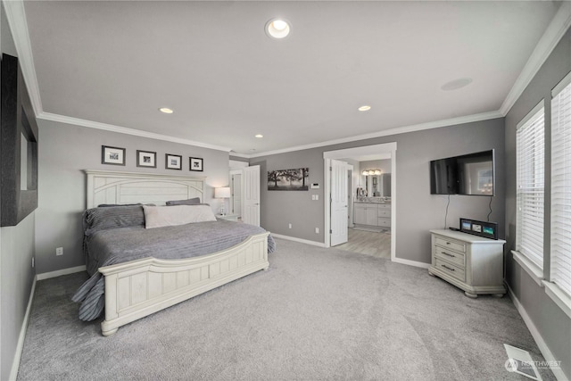 carpeted bedroom with crown molding and connected bathroom