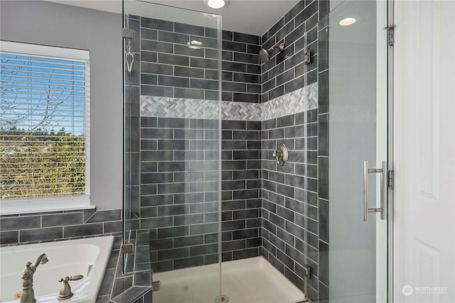 bathroom with shower with separate bathtub