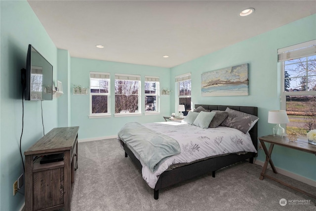 carpeted bedroom featuring multiple windows