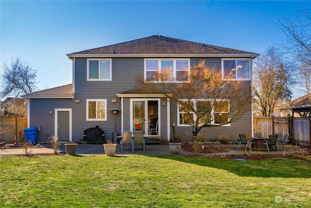 rear view of house with a yard and a patio area