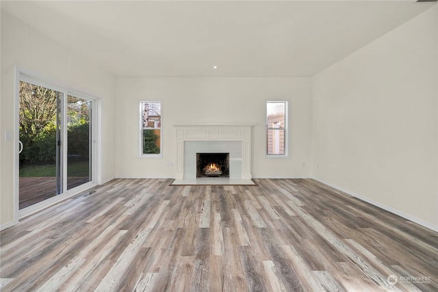 unfurnished living room with a wealth of natural light and light wood-type flooring