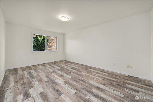 spare room featuring light wood-type flooring