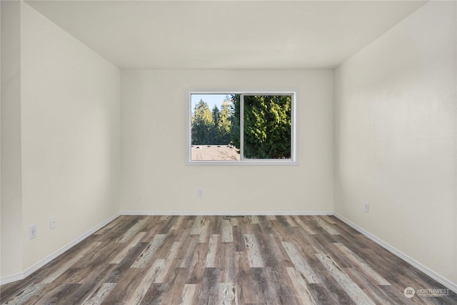 unfurnished room with hardwood / wood-style floors