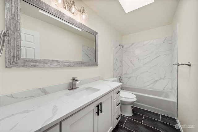 full bathroom with a skylight, tiled shower / bath combo, vanity, tile patterned flooring, and toilet