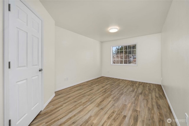 spare room with wood-type flooring