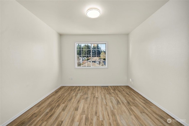 spare room with light wood-type flooring