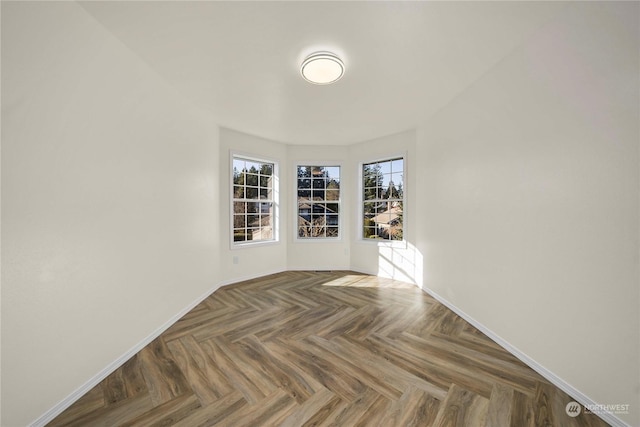 unfurnished room with dark parquet floors