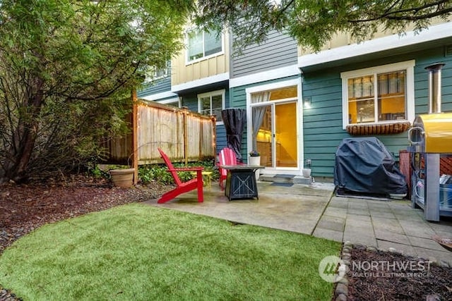 back of house with a patio and a yard