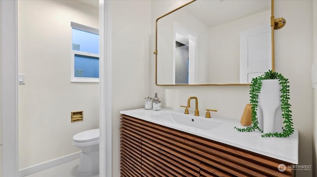 bathroom featuring vanity and toilet