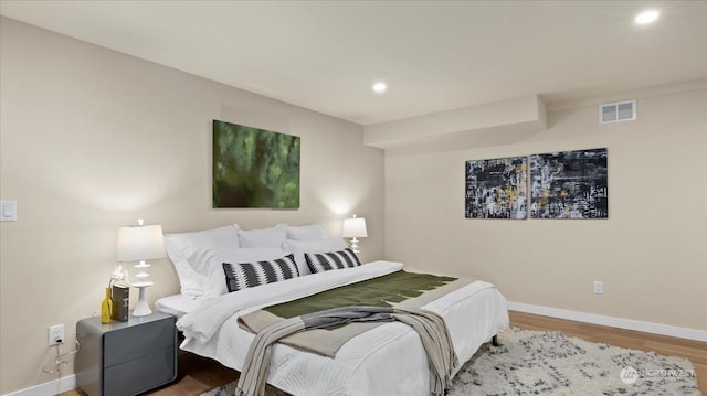 bedroom with hardwood / wood-style floors