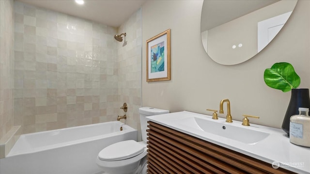 full bathroom with tiled shower / bath, vanity, and toilet