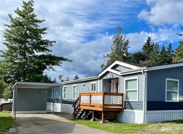 view of front facade with a carport and a deck