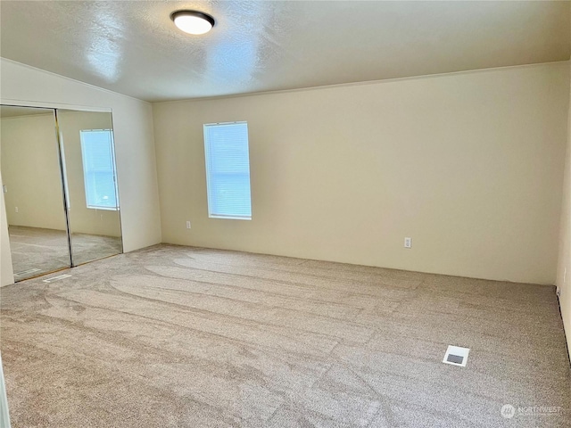 unfurnished bedroom featuring a closet, carpet flooring, and a textured ceiling