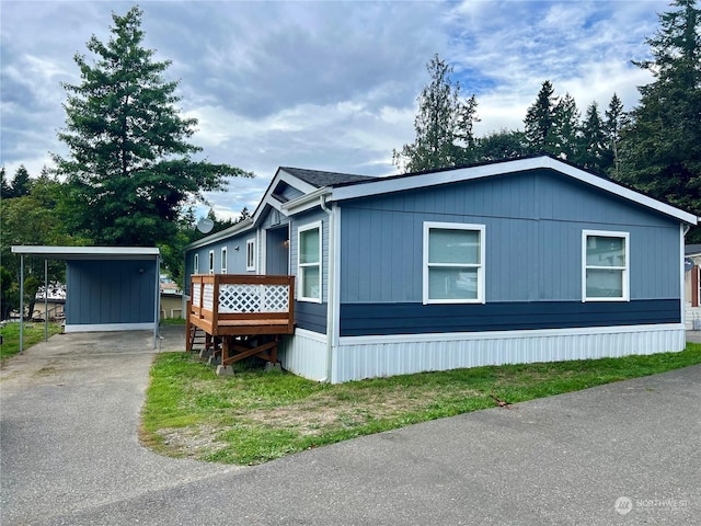 view of front of property with a carport and a deck