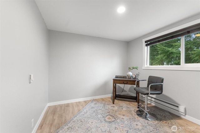 sitting room with baseboards and wood finished floors