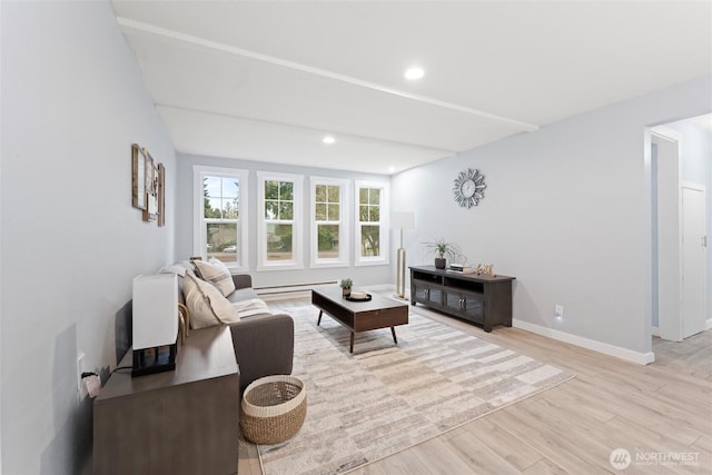 living room with light wood finished floors, recessed lighting, and baseboards