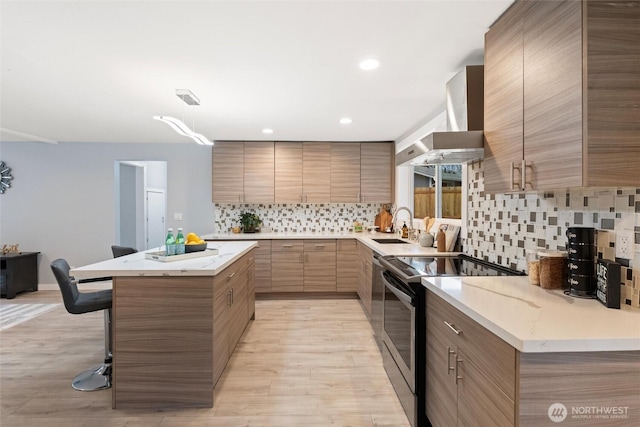 kitchen with a kitchen island, stainless steel electric stove, wall chimney exhaust hood, tasteful backsplash, and modern cabinets