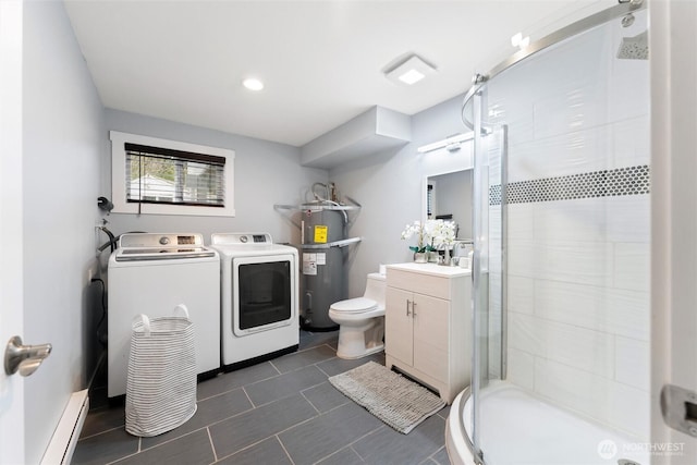 bathroom featuring washing machine and dryer, a baseboard heating unit, vanity, secured water heater, and a stall shower