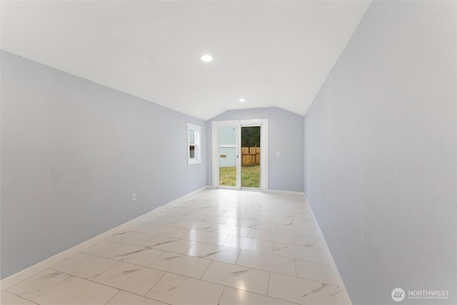 spare room with vaulted ceiling, marble finish floor, recessed lighting, and baseboards