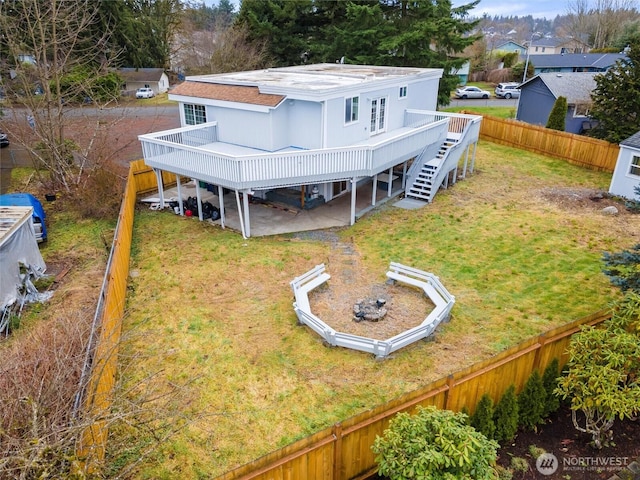 exterior space with a fenced backyard, a yard, stairway, and a wooden deck