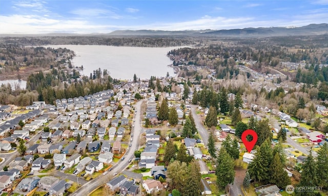 drone / aerial view with a residential view and a water and mountain view