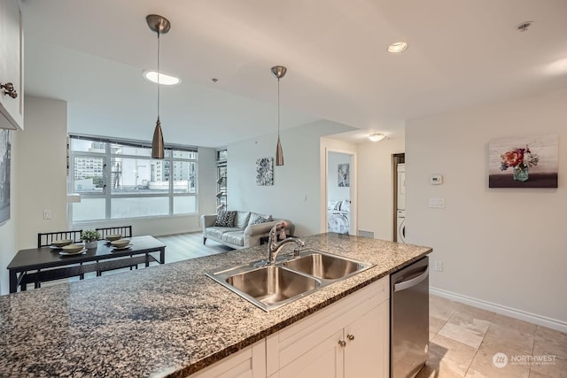 kitchen with white cabinetry, sink, dark stone countertops, hanging light fixtures, and stainless steel dishwasher