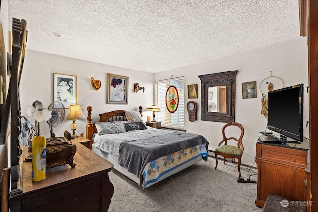 bedroom featuring light colored carpet and a textured ceiling