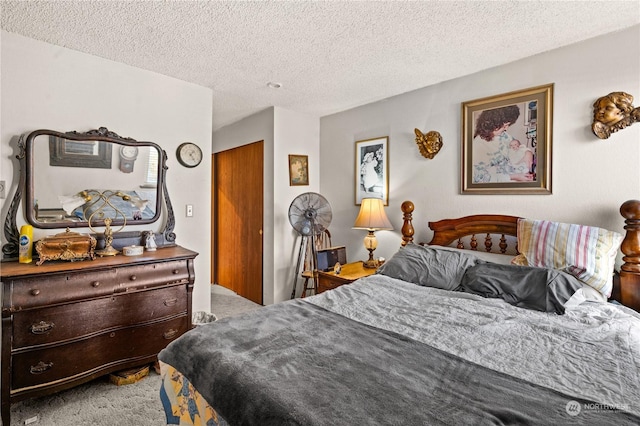 bedroom featuring carpet and a textured ceiling