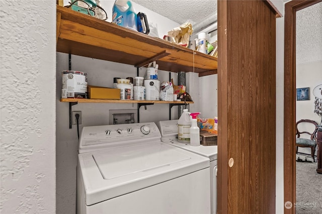 washroom with separate washer and dryer and a textured ceiling