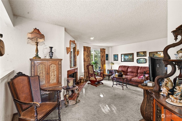 carpeted living room with a fireplace and a textured ceiling