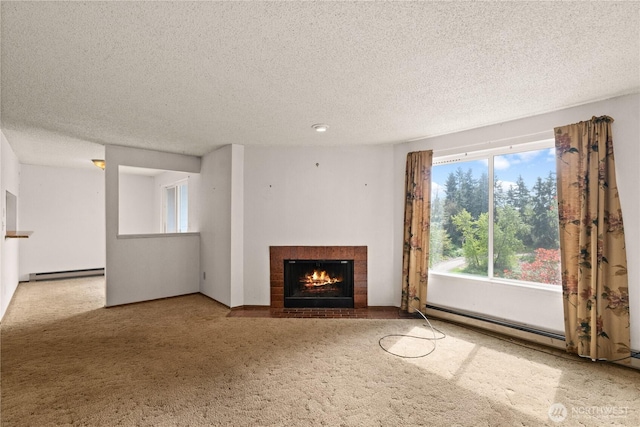 unfurnished living room featuring a fireplace with flush hearth, a textured ceiling, plenty of natural light, and baseboard heating