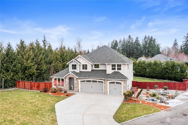 view of property with a garage and a front lawn