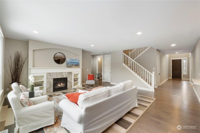 living room with wood-type flooring and a fireplace