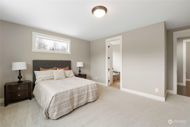 carpeted bedroom with ensuite bath