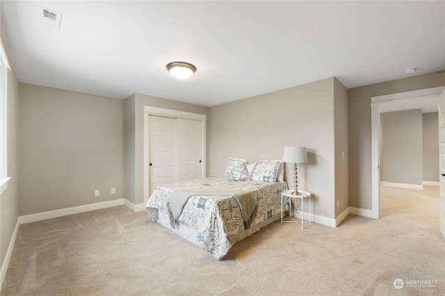 carpeted bedroom featuring a closet