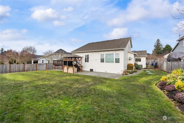 rear view of house featuring a yard, a patio, and a gazebo