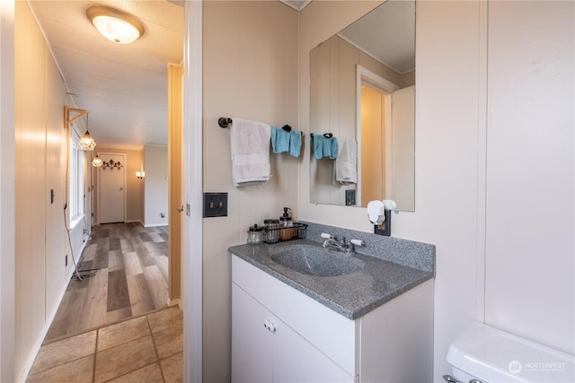 bathroom featuring vanity, tile patterned flooring, and toilet