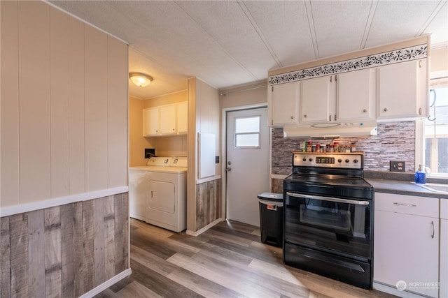 kitchen featuring black electric range oven, white cabinetry, tasteful backsplash, separate washer and dryer, and light hardwood / wood-style floors